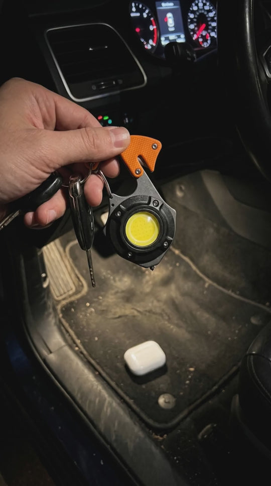 Sentinel keychain light finding earbuds under a car seat