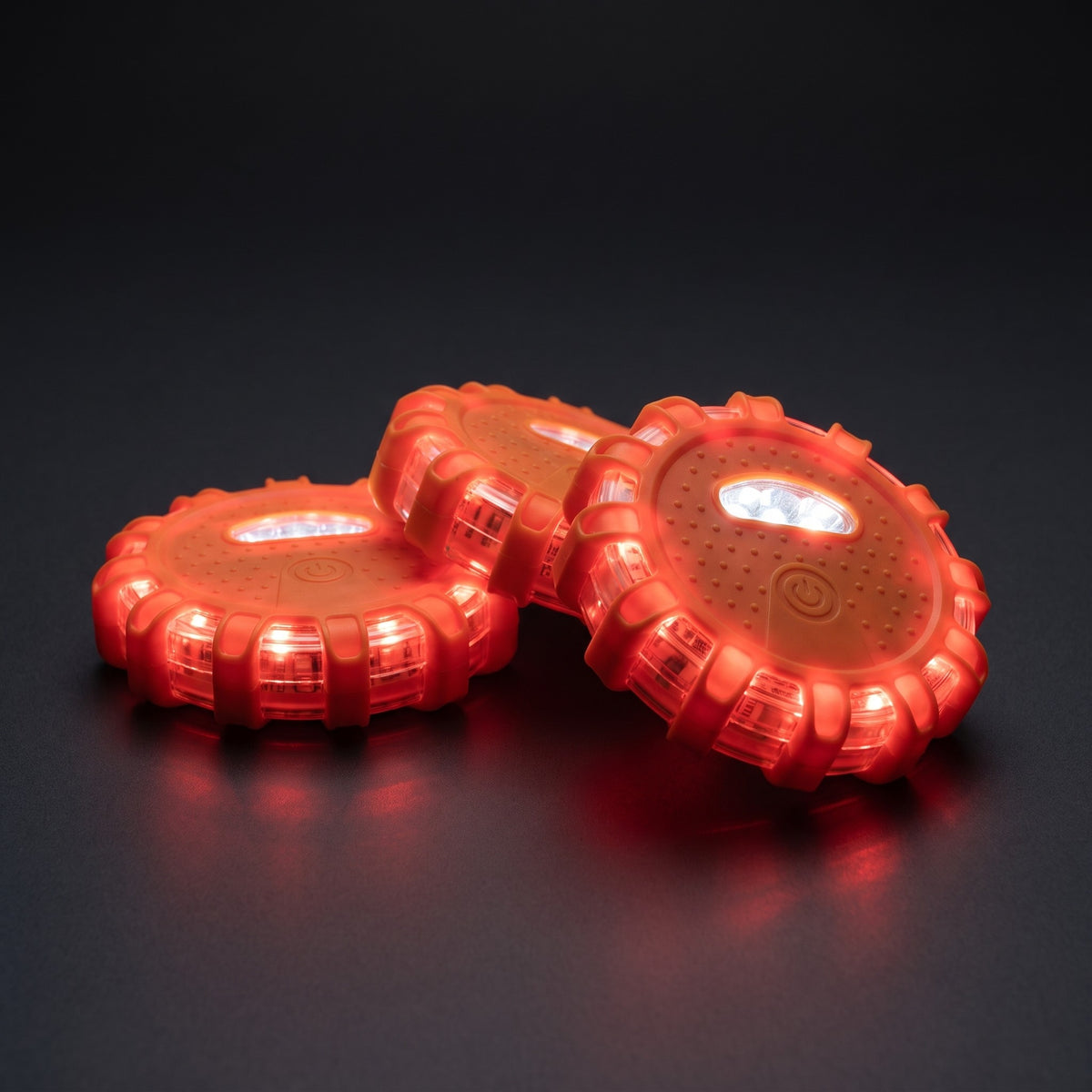 Three Warden Beacon LED road flares glowing red